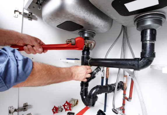 plumber fixing a leaky sink in Wiltshire