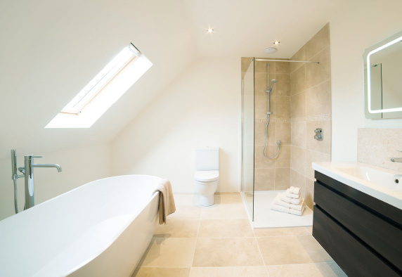 A newly fitted bathroom with new taps, shower and bath in Wiltshire